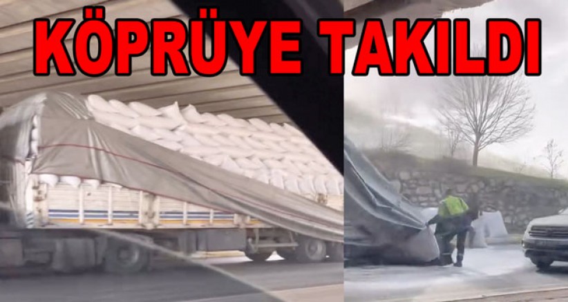TIRA FAZLA YÜKLEDİ KÖPRÜYE TAKILDI